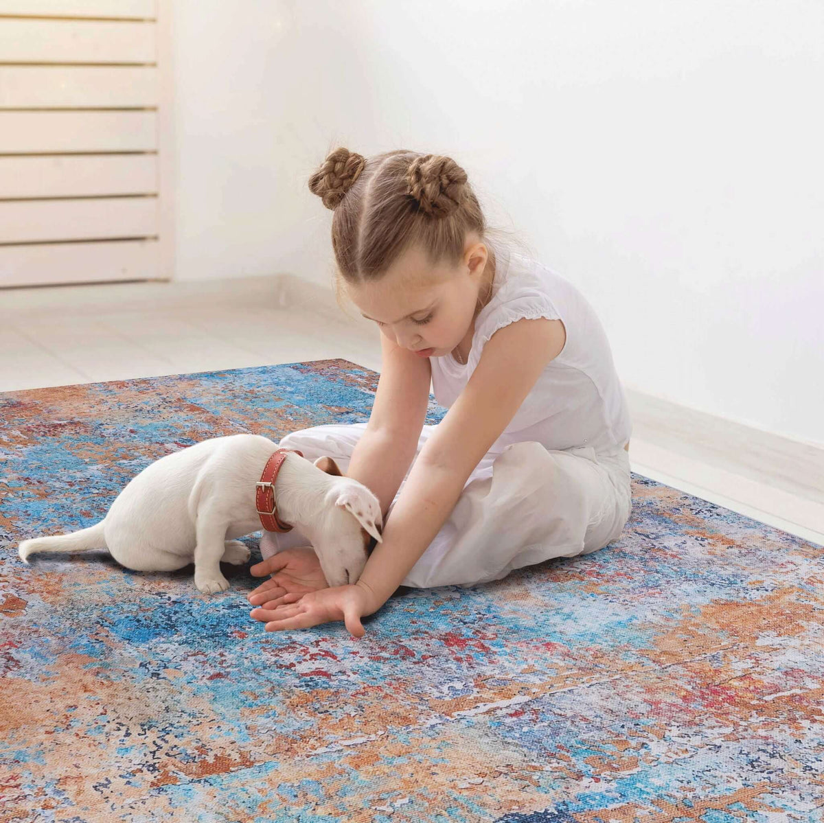 washable stain-resistant area rug in blue abstract design with child and puppy playing