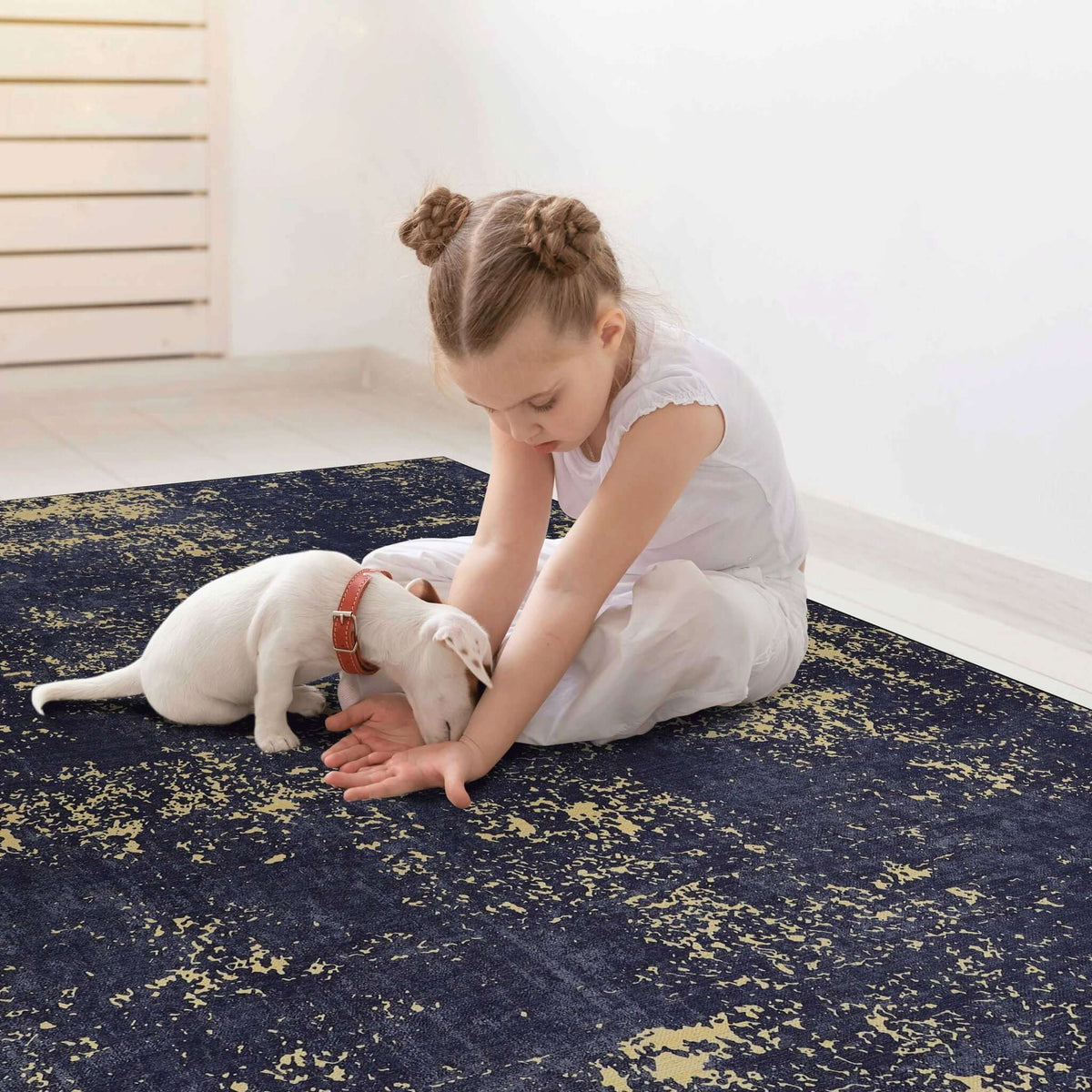 machine washable stain-resistant area rug in black with gold abstract design, child and puppy playing