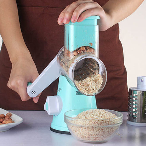 Manual Kitchen Accessories multifunctional mandoline vegetable slicer in use, grating peanuts into a bowl.