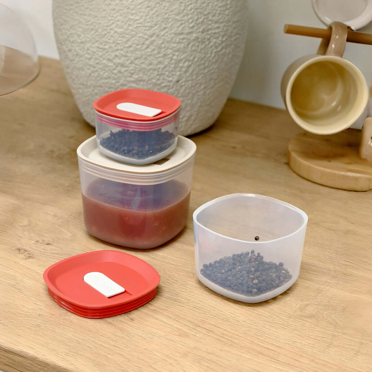 Set of glass meal prep containers with airtight silicone vent lids.