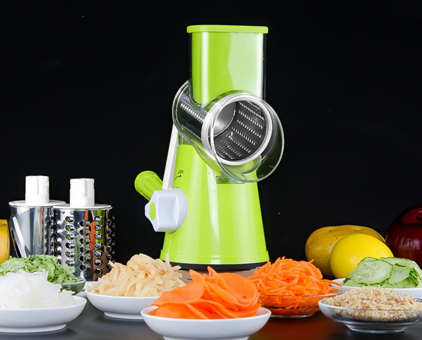 Mandoline vegetable slicer in green with sliced vegetables and cheese on display, perfect for food preparation.