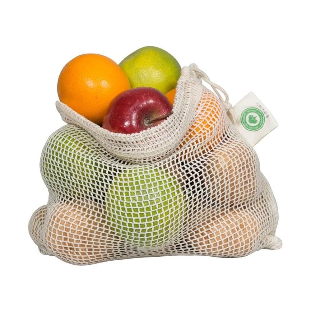 Organic cotton produce bags filled with various fruits for eco-friendly shopping.