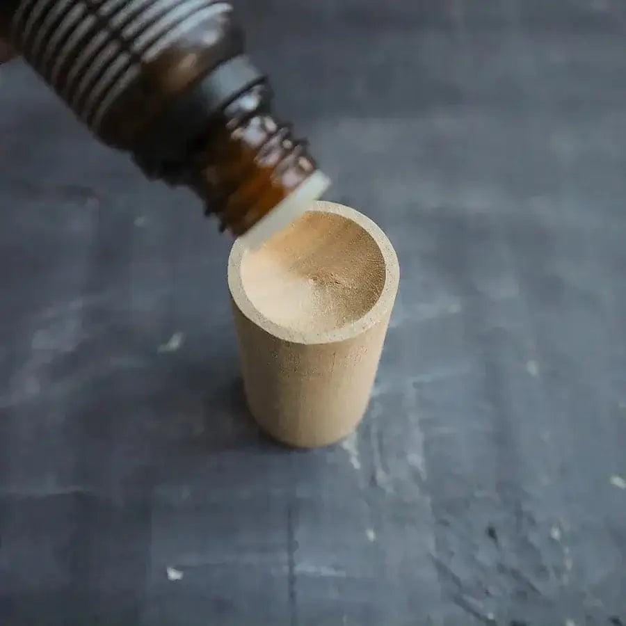 Portable essential oil diffuser with a natural wooden design for aromatherapy on the go.