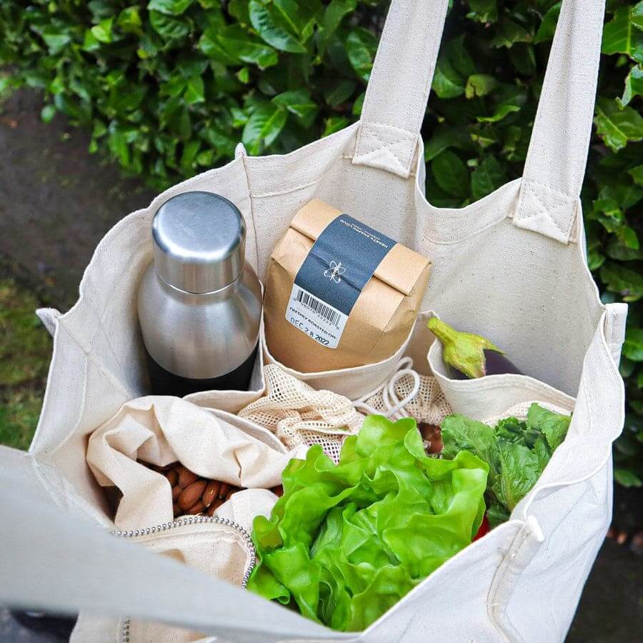 Reusable organic cotton produce bags set for grocery shopping, holding fresh produce, snacks, and pantry items.