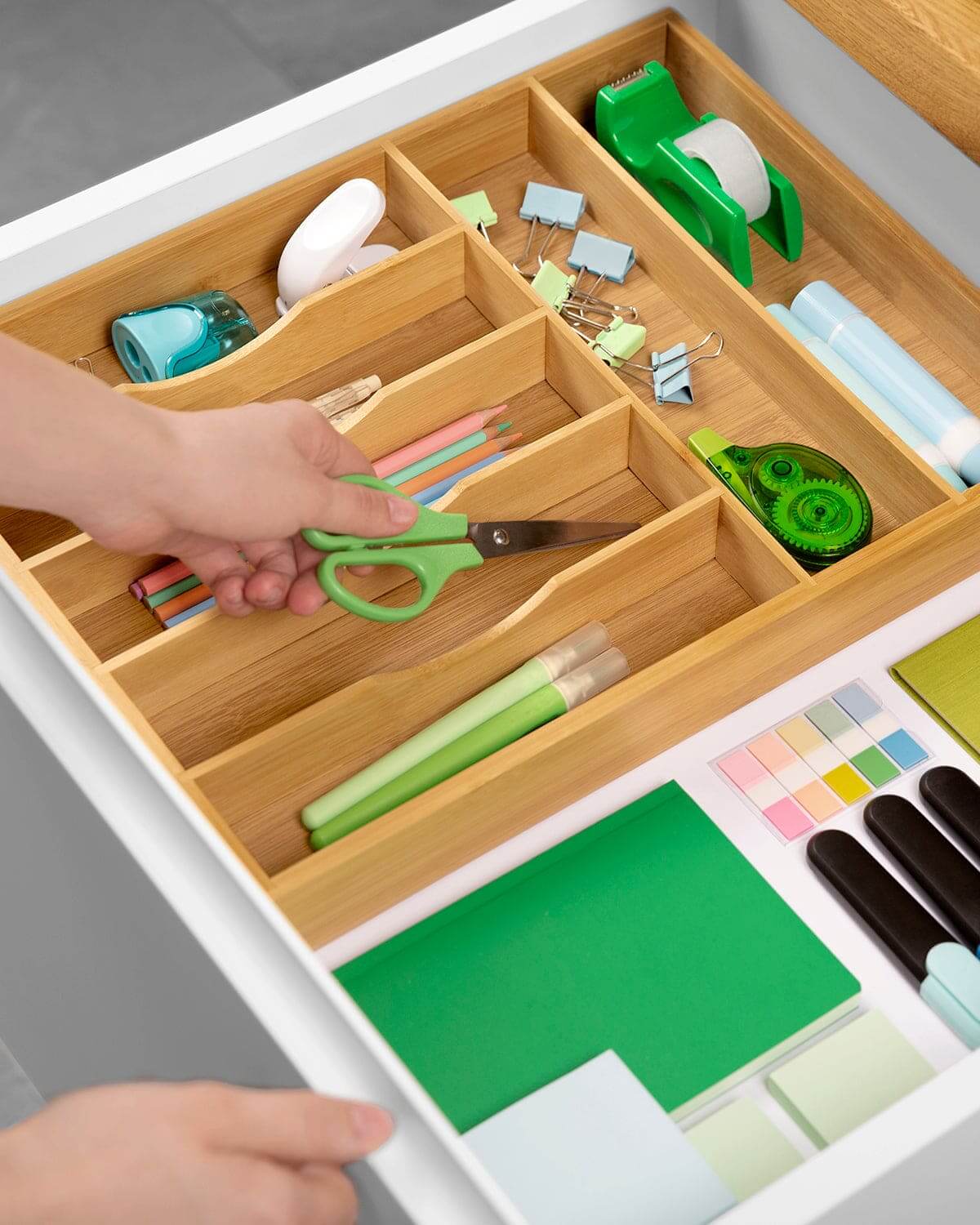 bamboo silverware drawer organizer with separate slots organizing kitchen utensils and office supplies