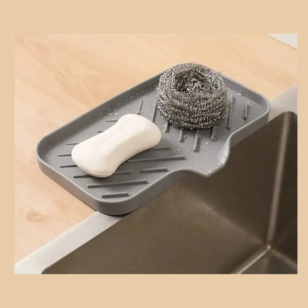 Silicone auto-draining sponge holder efficiently channels water away and keeps sponges dry, promoting cleanliness and organization.