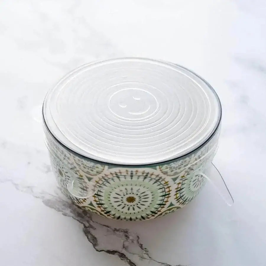 Reusable silicone bowl covers folded compactly for storage in a kitchen drawer.