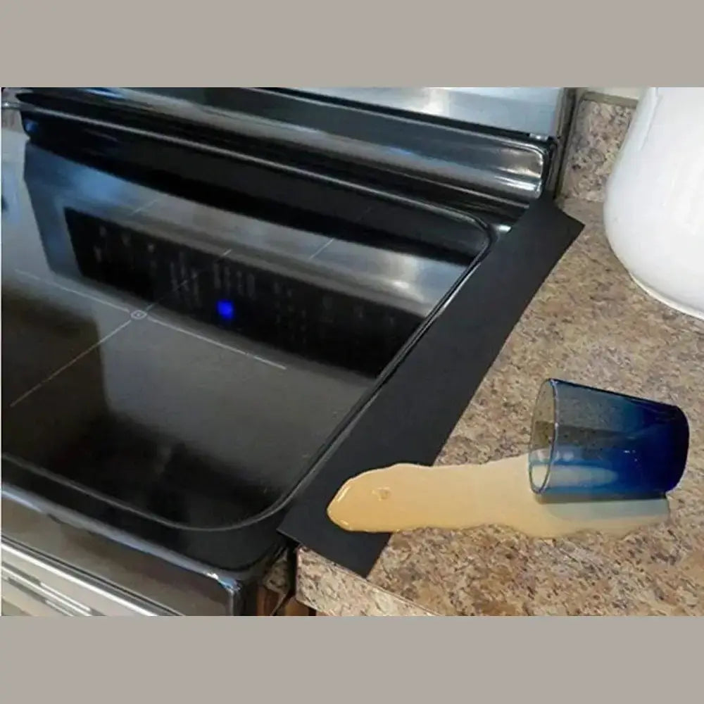 Silicone stove counter gap cover in use next to a kitchen sink to catch spills.