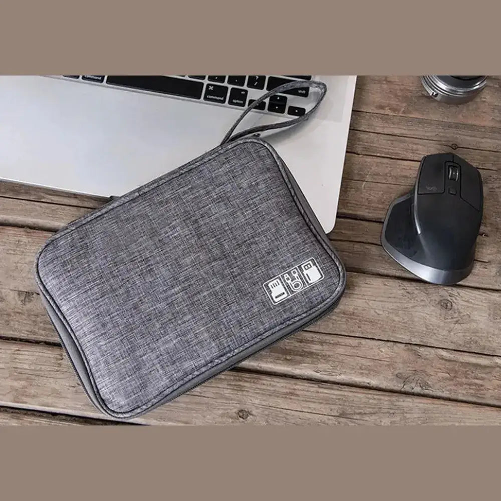 waterproof electronics organizer bag placed near a laptop and mouse