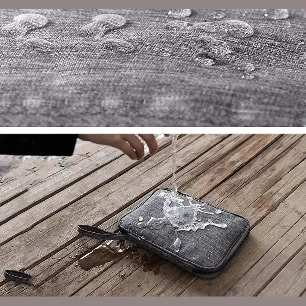 Waterproof electronics organizer bag with water droplets protecting cables and chargers.