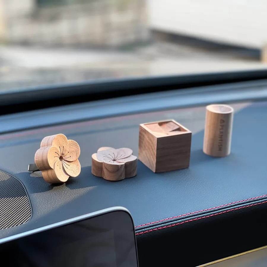 Portable essential oil diffuser with a natural wooden design for aromatherapy on the go.